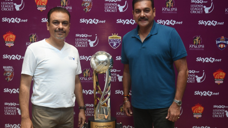 Caption: Legends League Cricket Co-founder & CEO Raman Raheja and Legends League Cricket Commissioner Ravi Shastri pose with the League trophy in Kolkata on Friday